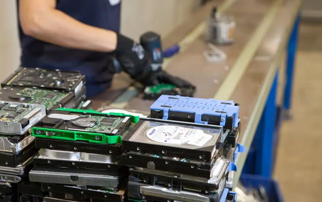 Technician processing retired IT equipment for disposition
